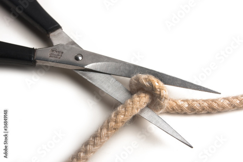 Scissors cutting a rope