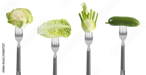 fresh green baby vegetables on forks photo