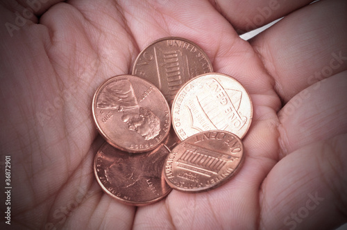 Картината върху платно Hand holds some coins. Concept of poverty.