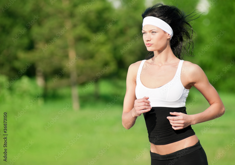 Fototapeta premium Woman running in green park