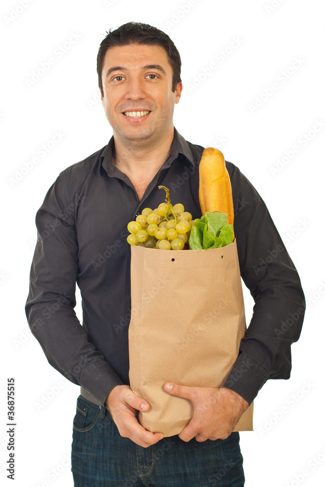 Cheerful man carrying shopping bag with food Cheerful man carrying shopping bag with food