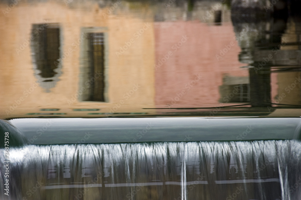Reflections of colored walls and waterfall in Annecy