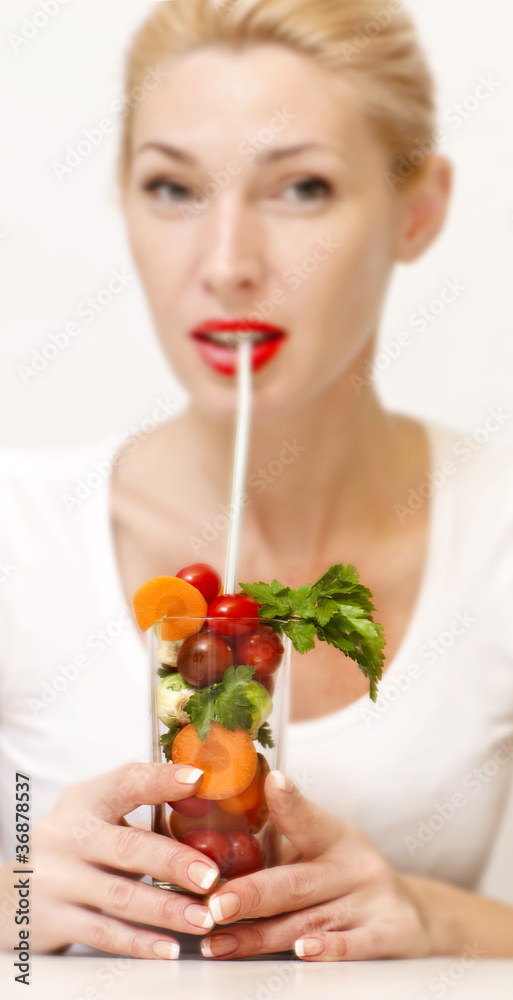 Concept image of a woman holding a glass of vegetables Concept image of a woman holding a glass of vegetables
