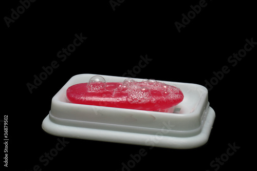 soap dish with bubbles covered soap on black