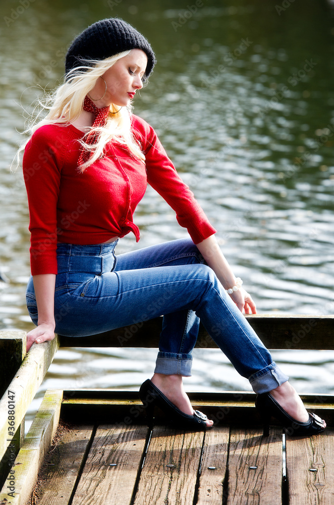 Beautiful young woman thinking outdoors by river Beautiful young woman thinking outdoors by river