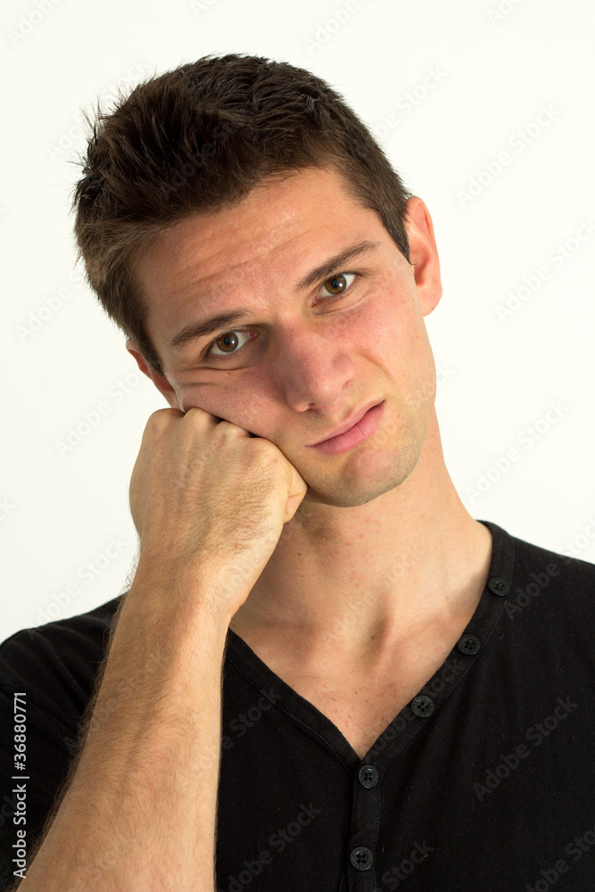 Worried young man with hand on face Worried young man with hand on face