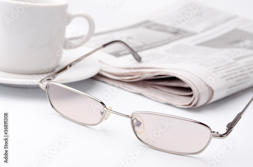 Eyeglass and newspaper