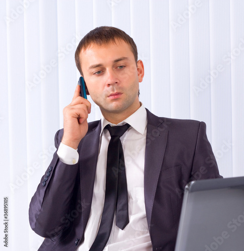 Business man working at office and calling on phone