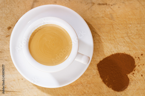 espresso coffee in thick white cup with cocoa heart