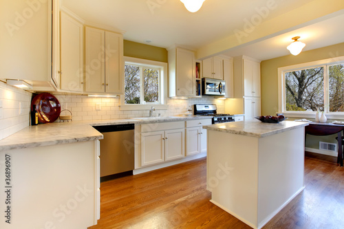 White and green kitchen with luxury design.