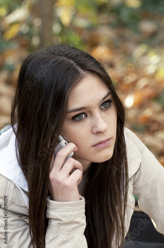 Beautiful teen girl talking on cell phone