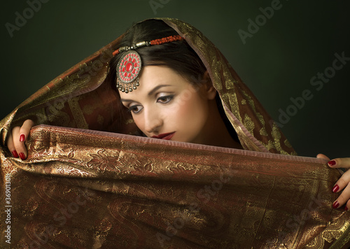 Beautiful brunette portrait with traditionl costume. Indian styl photo