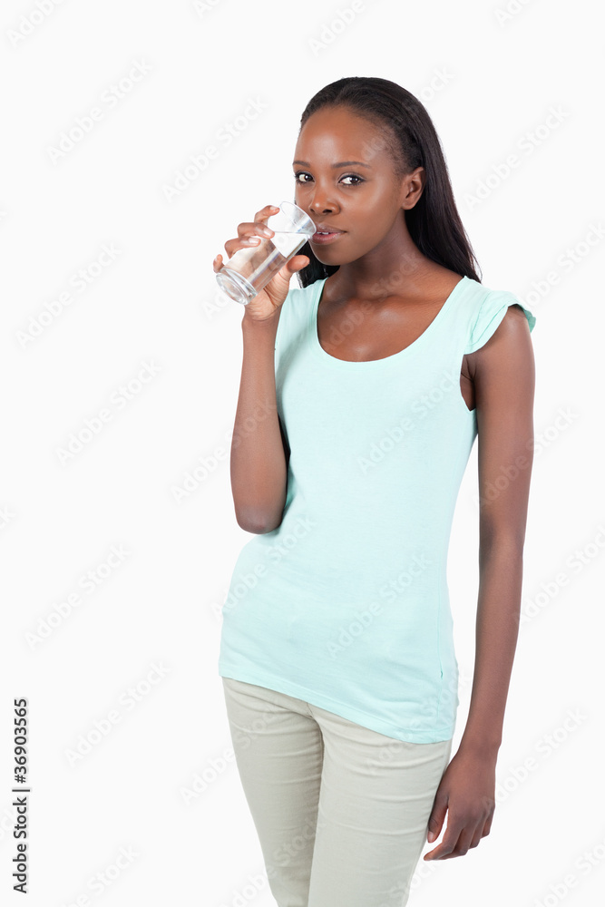 Young woman drinking a glass of water Young woman drinking a glass of water