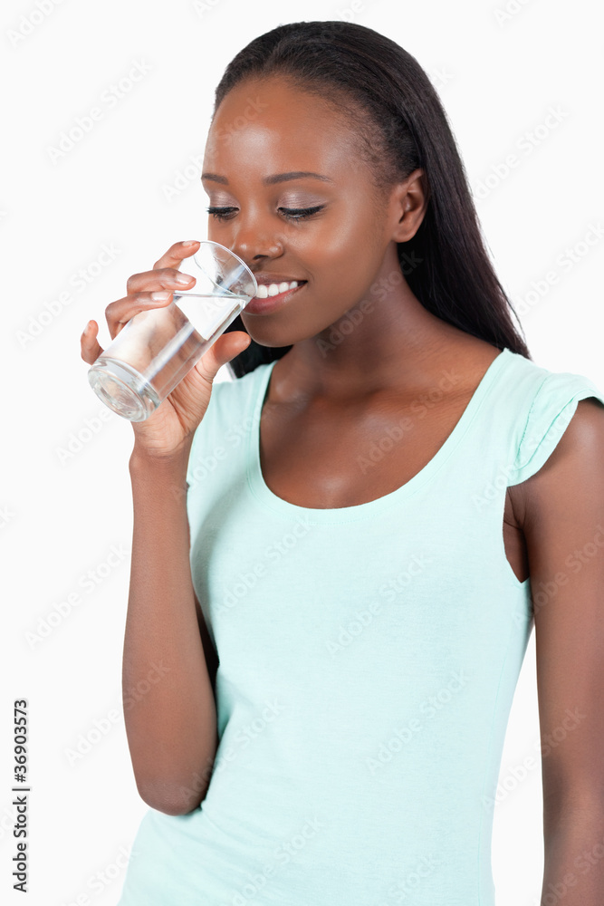 Young woman looking into her glass of water Young woman looking into her glass of water