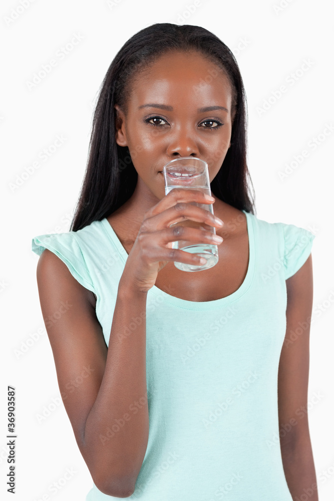 Young woman taking a sip of refreshing water Young woman taking a sip of refreshing water