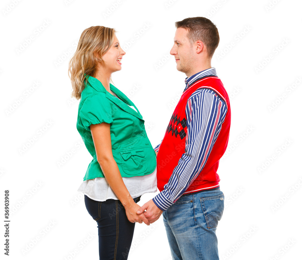Smiling pregnant woman with husband looking on each other Smiling pregnant woman with husband looking on each other