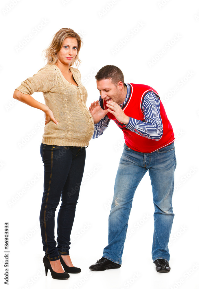 Husband speaking with pregnant wifes belly Husband speaking with pregnant wifes belly
