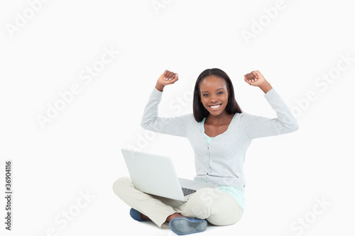 Young woman celebrating a successful online auction © WavebreakmediaMicro