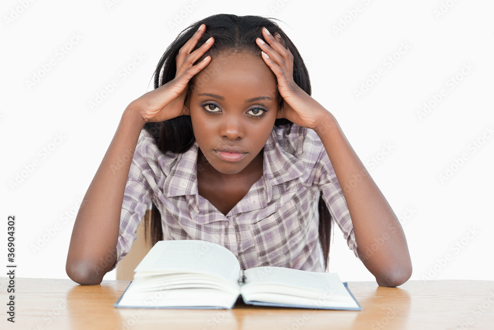 Bored student trying to read a book