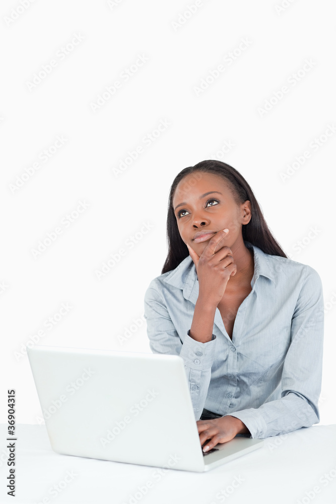 Portrait of a thoughtful businesswoman using a laptop Portrait of a thoughtful businesswoman using a laptop