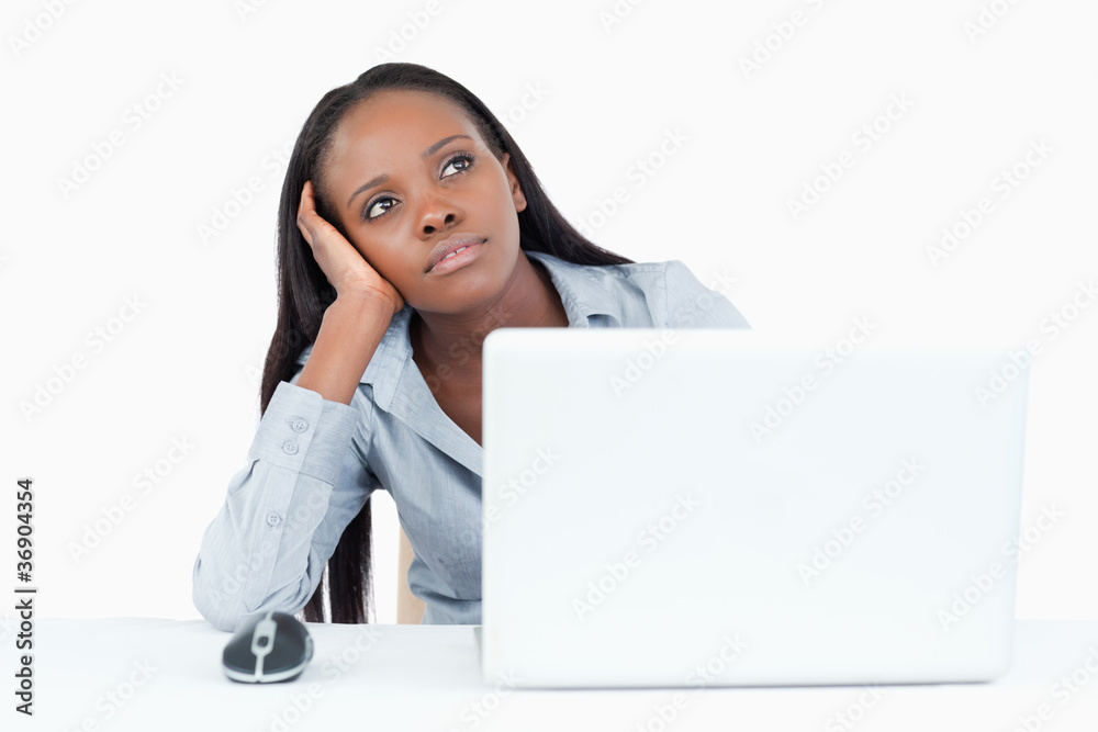 Businesswoman day dreaming while using a laptop Businesswoman day dreaming while using a laptop