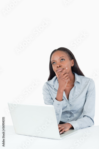 Portrait of a thoughtful businesswoman using a laptop