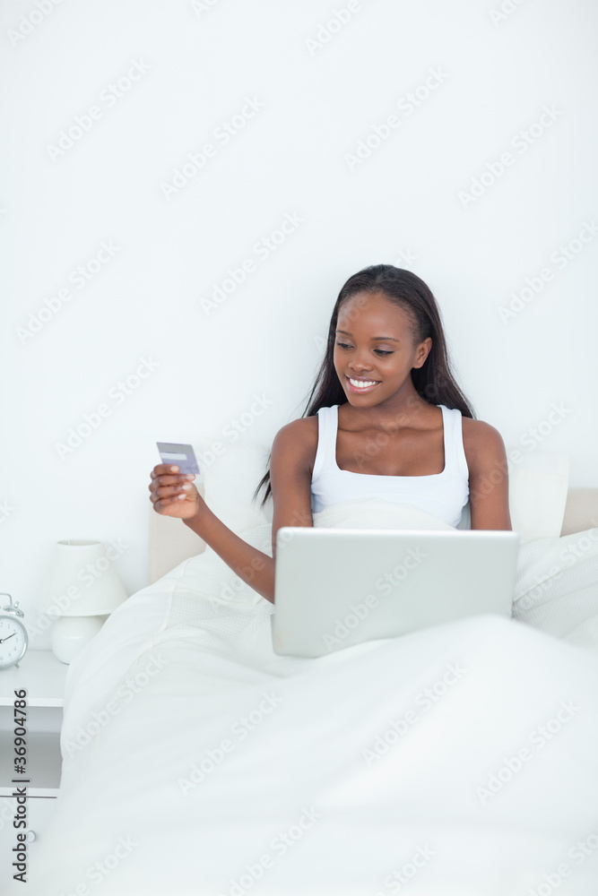 Portrait of a young woman booking her holidays online Portrait of a young woman booking her holidays online