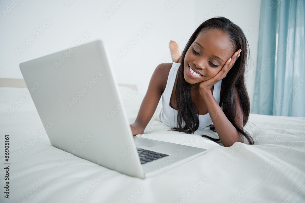 Young woman watching a movie on her notebook Young woman watching a movie on her notebook