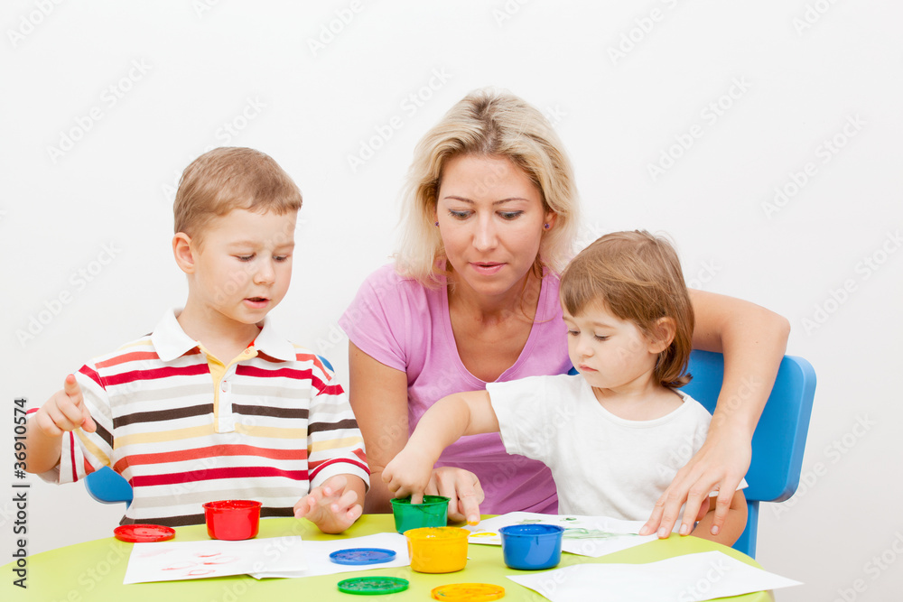 Fototapeta premium brother and the sister draw finger-type paints