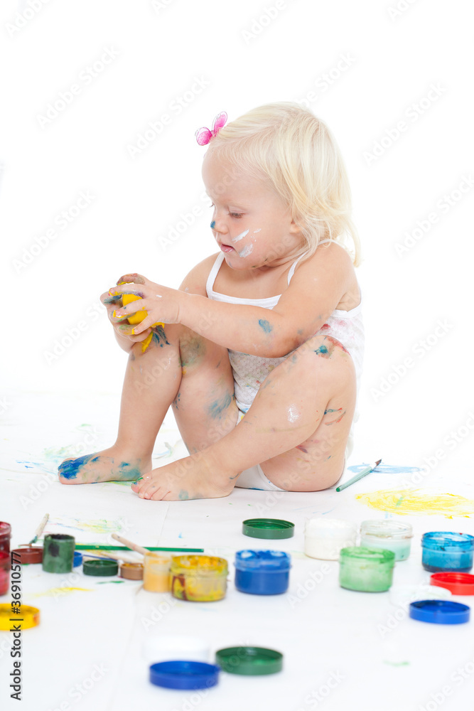 little girl bedaubed with bright colors little girl bedaubed with bright colors