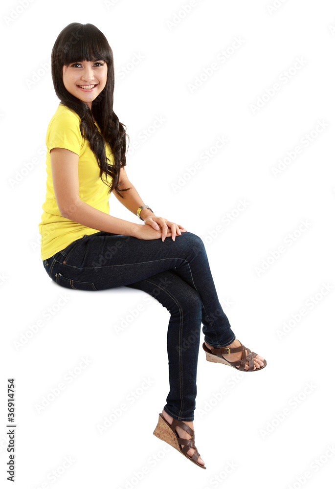 Pretty girl sitting on big blank billboard poster sign Pretty girl sitting on big blank billboard poster sign