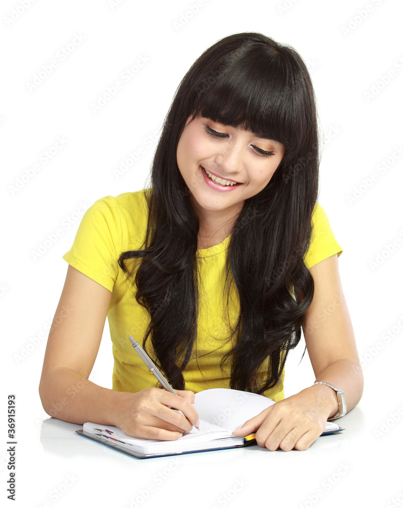 an asian college girl writing a book an asian college girl writing a book