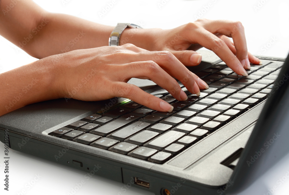 close up of female hand typing on a laptop close up of female hand typing on a laptop