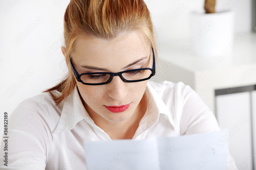 Closeup on woman reading files.