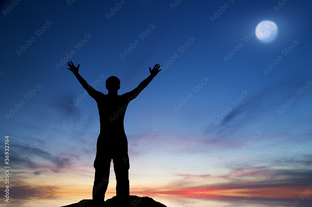 Silhouette of the person seeing off the coming sun Silhouette of the person seeing off the coming sun