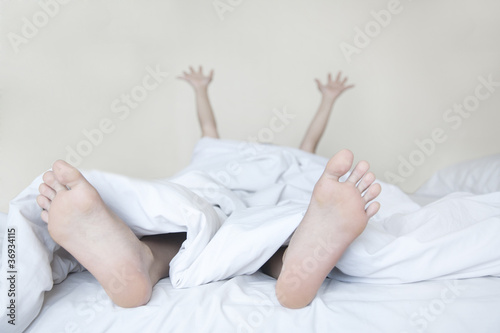 Woman stretching in bed