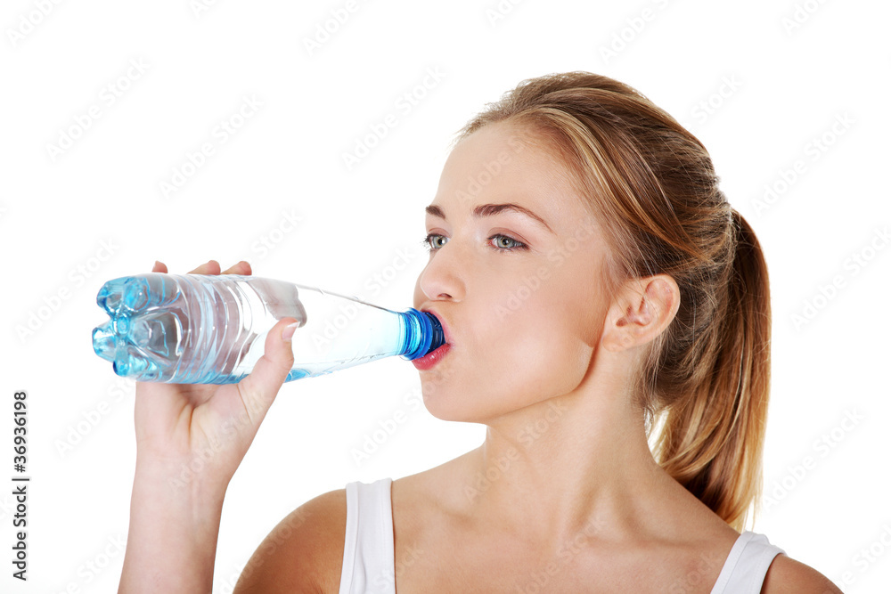 Teen drinking mineral water from bottle Teen drinking mineral water from bottle