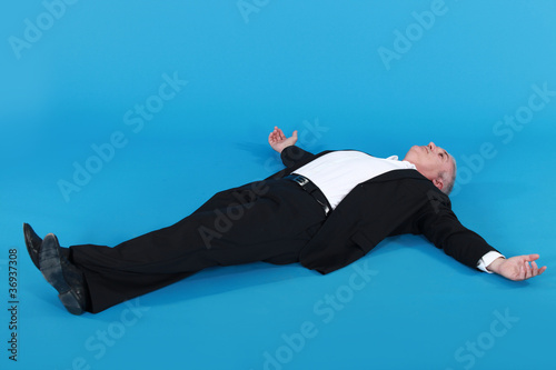 Photography man lying against blue background