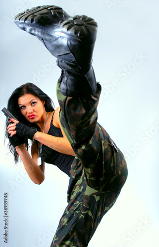 girl with gun  in kick moving © yogo