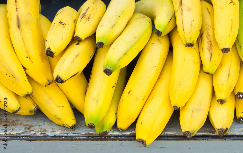 Closeup of heap of bananas for sale.