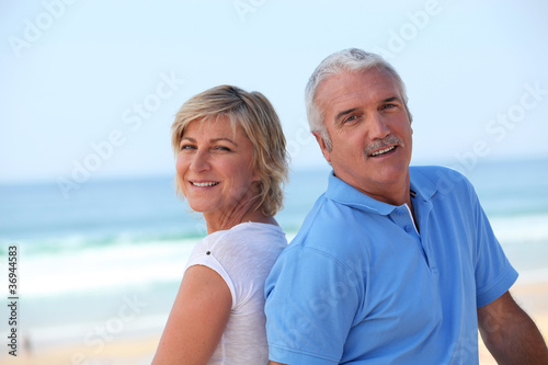 happy senior couple on the beach