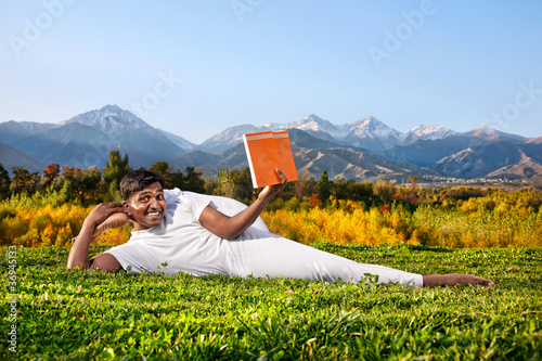 Yoga man reading the book photo