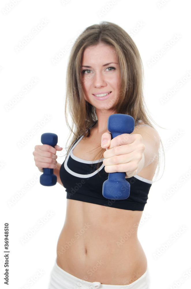 The girl does exercises with dumbbells isolated The girl does exercises with dumbbells isolated