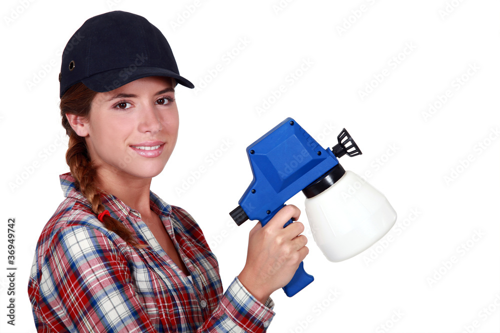 Woman holding spray for painting