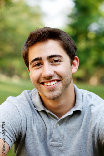 Handsome young man portrait at the park