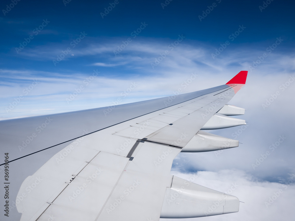 Airplane flying above the clouds