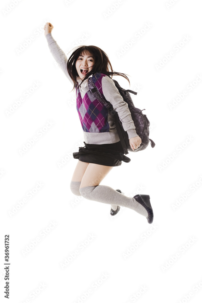Chinese school girl jumping into air.