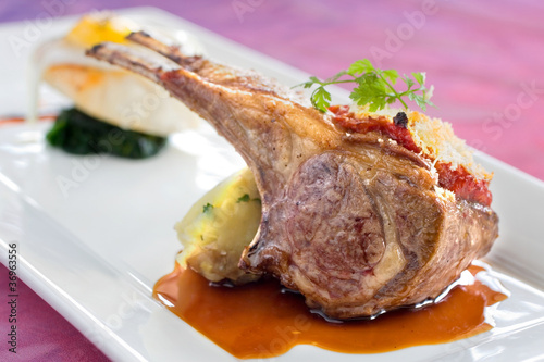 Seared and roasted lamb ribs with baked potato