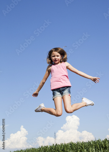 young girl exercising jumping in the air