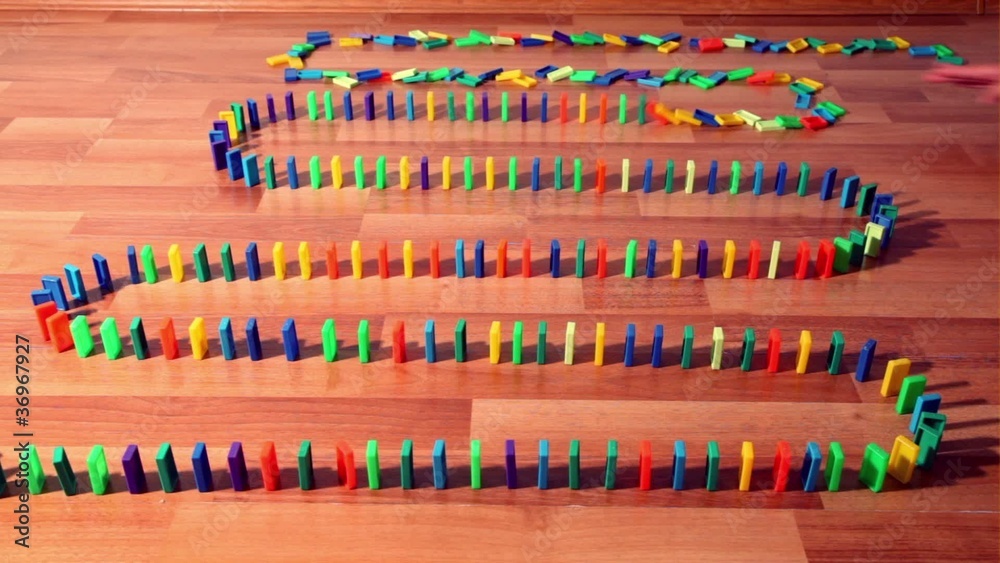 Dominoes row begin to fall down one by one